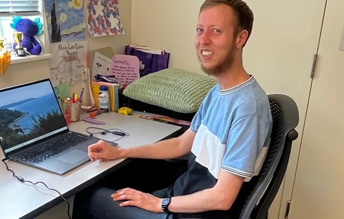 Jed Walsh smiling at their computer