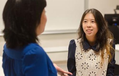 A woman is having a conversation with a student