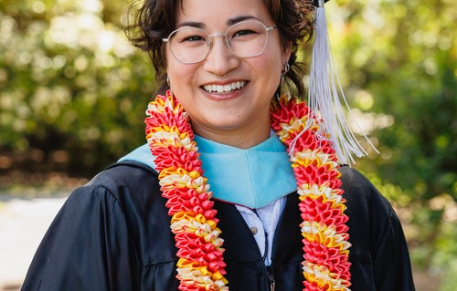 Erin Kwan smiling in graduation garb