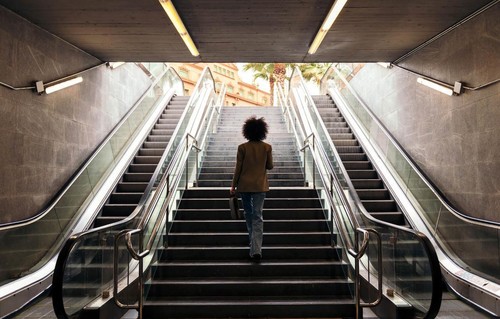 A woman walking up a flight of stairs