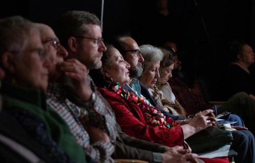 Audience members sitting in reflection