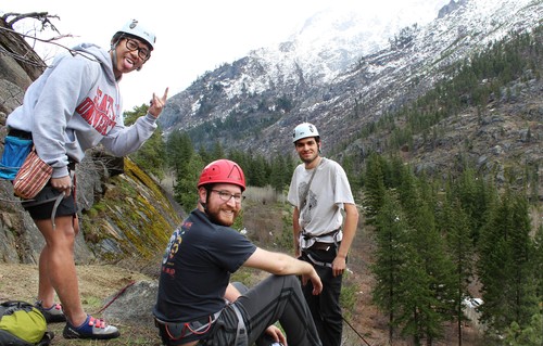 A group of men in helmets on a mountain.
