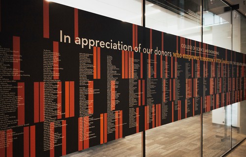 A photograph of Donor names printed on a wall in the Sinegal Center
