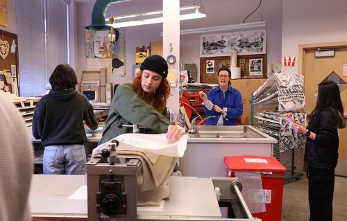 Students and professor in printmaking class.