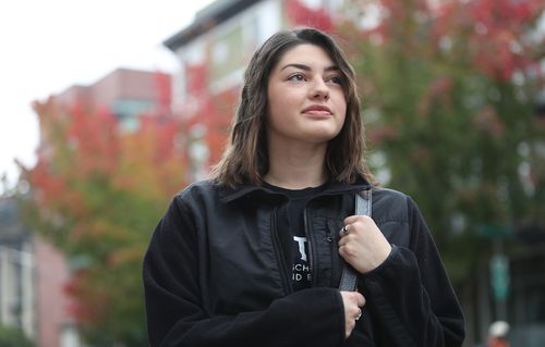 Student with fall foliage in background