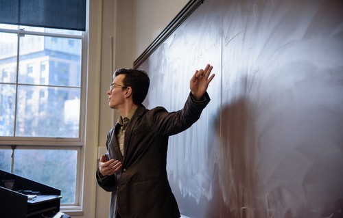 Alumnus and faculty member Jerome Veith at chalkboard