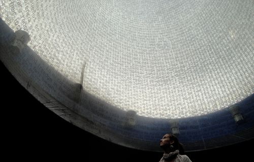 Woman under a glass mosaic dome