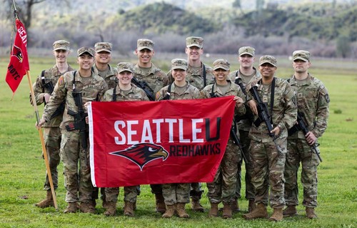 Army Cadets in front of Seattle U flag