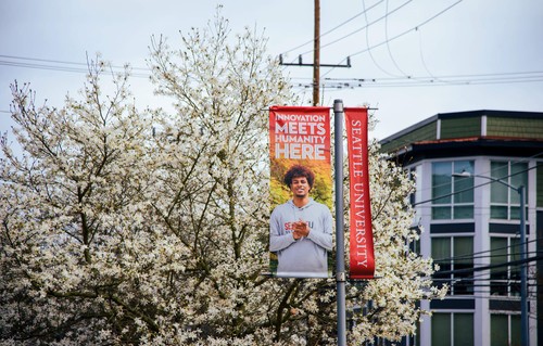 A lightpost banner showing a student and the words Innovation Meets Humanity Here