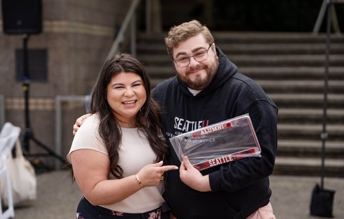A female and male student admiring a license plate holder