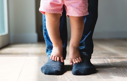 Father with baby on his feet