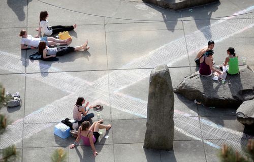 Overhead photo of Seattle University students sitting on the quad surrounded by chalk drawings