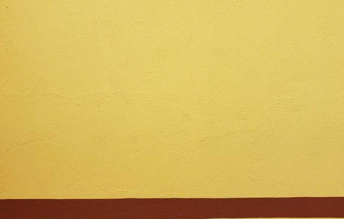 Yellow Wall with Two Maroon Stripes at the Bottom