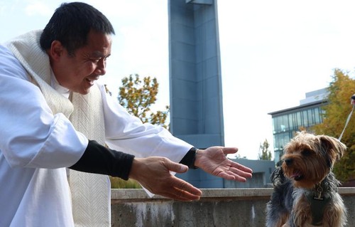 Blessing Animal priest with brown dog.jpeg