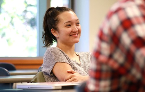 Smiling student with crossed arms