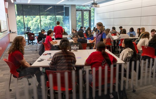 A group of people sitting at tables.