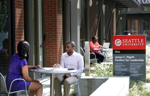 A man and woman sitting at a table.