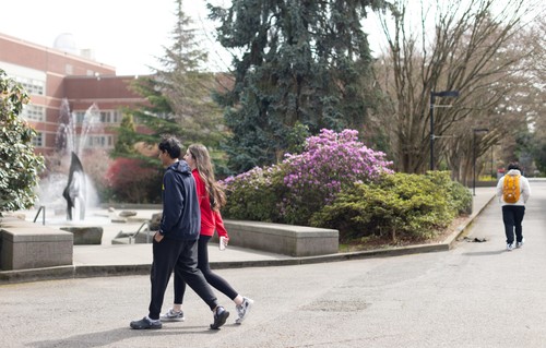 A man and woman walking on a street.