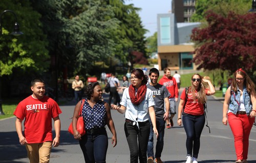 A group of students walking down a street.