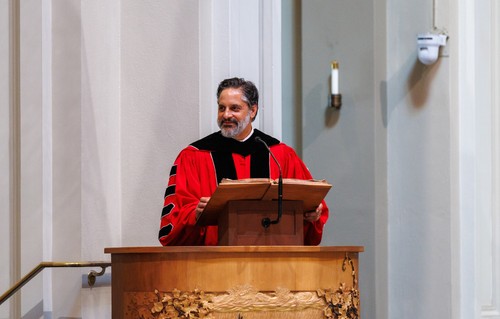 President Peñalver in regalia standing at a podium