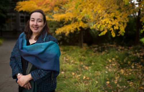 Woman in front of fall foliage