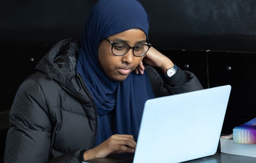 Woman looking at laptop