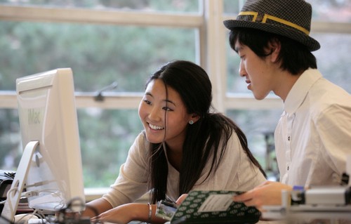 Man and Woman looking at a computer