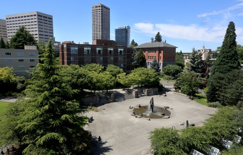 An aerial view of a park with trees and buildings.