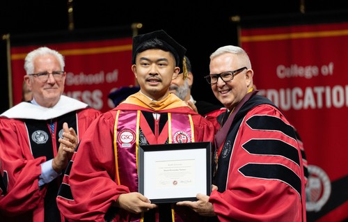 Daniel Tamayo receives Hunthausen award from Provost Shane Martin