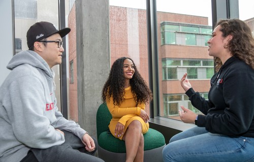 Three students talking, including Belen Mesele, DNP Class of '22