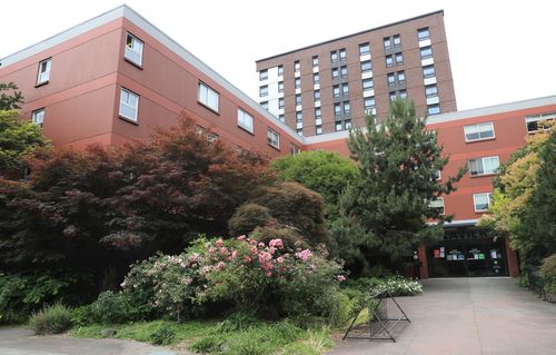 landscaped courtyard and entrance to Xavier Global House with Vi Hilbert Hall in the background