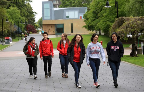A group of people walking on a brick path.