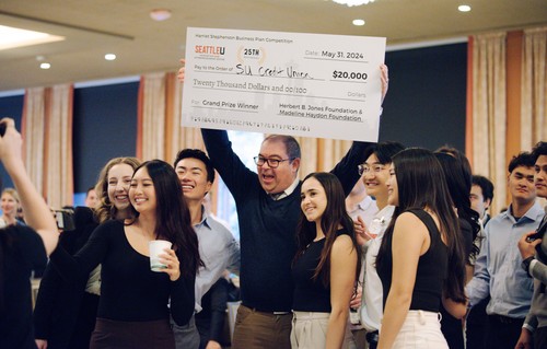 Group of students holding a giant check