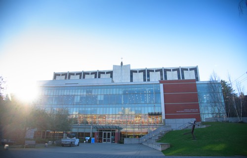 An image of a building with a sun shining on it.