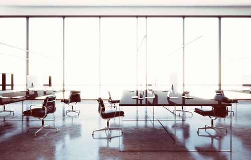An office space with empty chairs and desks