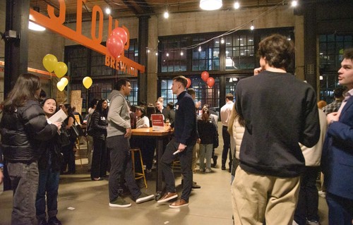 Students networking at an evening event