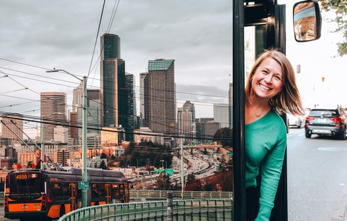 A photograph of Michelle Allison combined with a photo of the city of Seattle