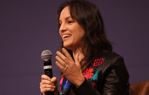 Journalist Monica Guzman speaking into a microphone