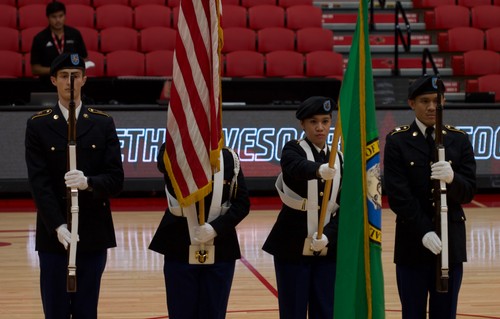 Four Cadets in dress uniform w/ flags