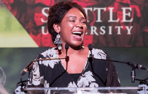 A photo of Essence Russ standing in front of a podium at an SU Gala