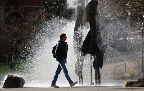 Student walking past the fountain