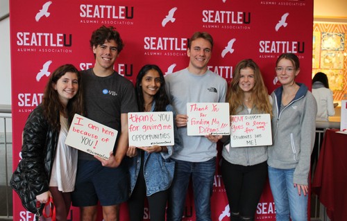 Thankful students holding signs at a photobooth