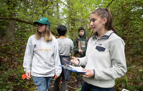 Students taking notes outside