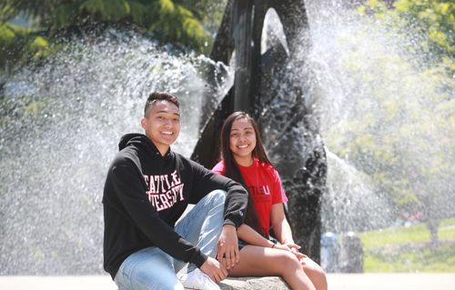 Two students sitting on campus