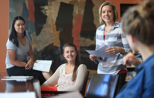 Groups of women talking and holding paper