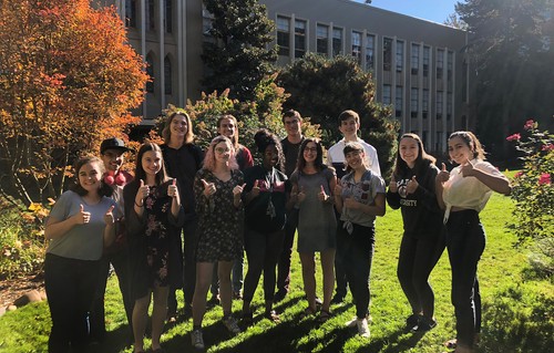 Students standing on grass in front of Administration Building