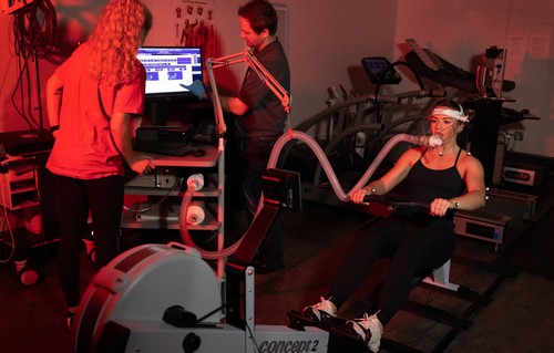 Student and instructor looking at results during rowing test