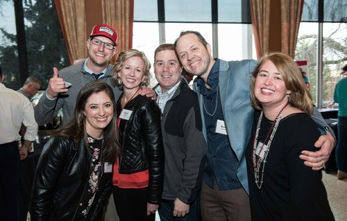 A group picture of people smiling at an event