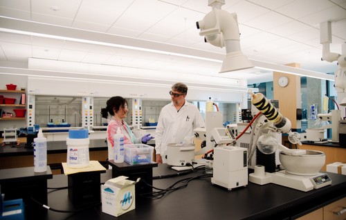 Professor and student working in a lab.