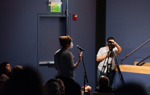 An audience member at an event asking a question.